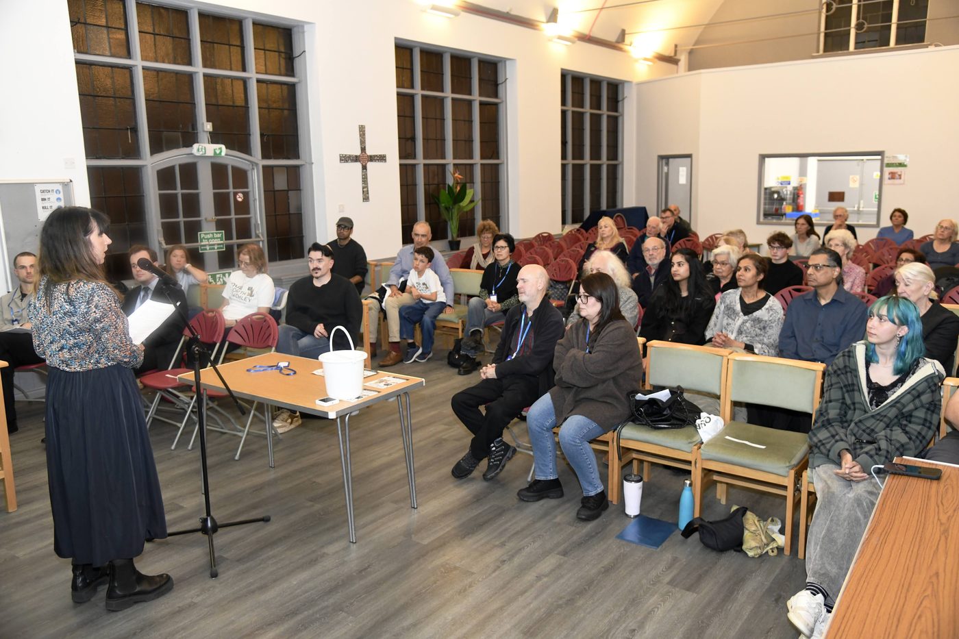 A speaker addresses a full hall at the Our North Finchley public meeting, St Alban’s Church Hall